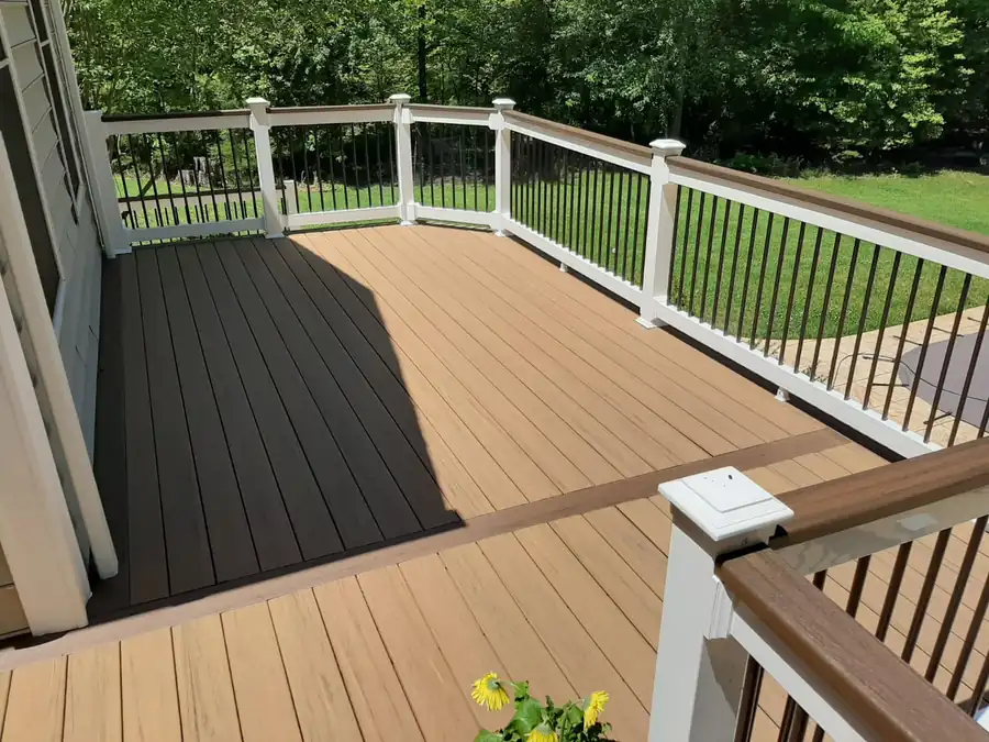 Composite deck with two-tone boards, white posts and black balusters